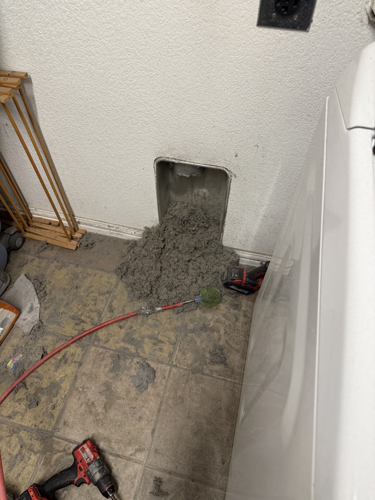 Pile of lint pulled out of a wall dryer vent during cleaning
