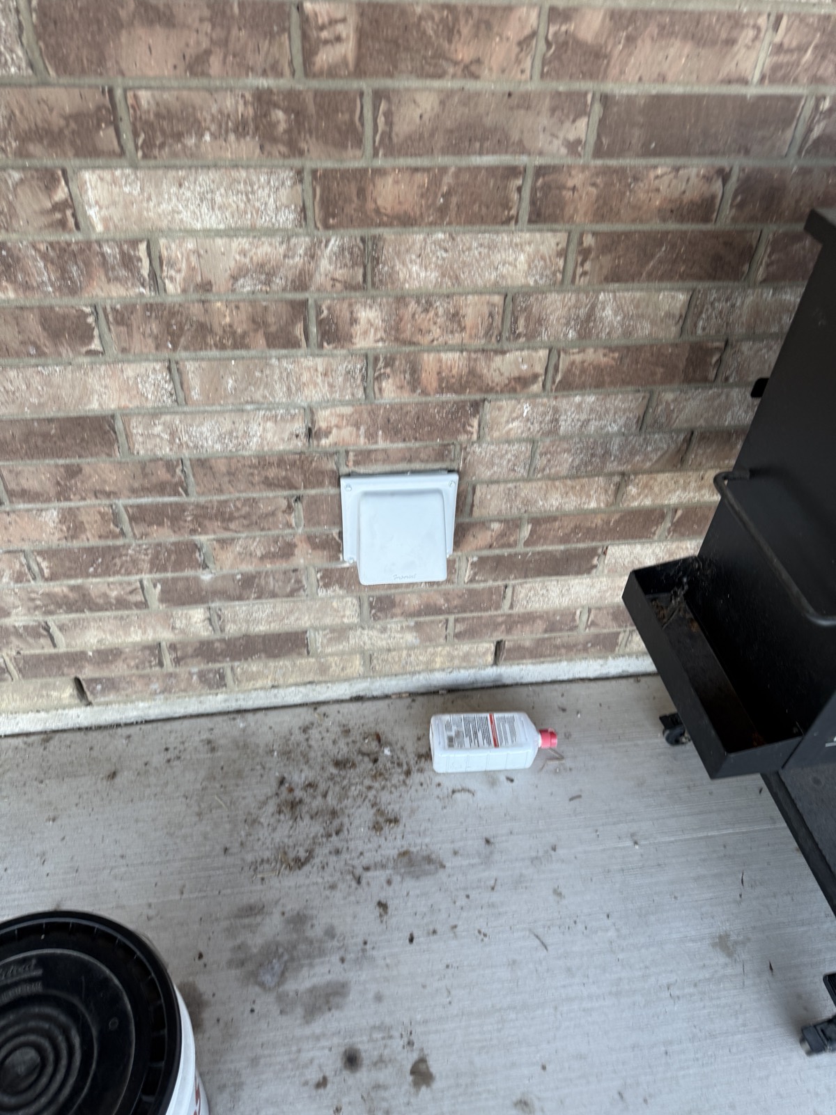 Exterior dryer vent hood installed on a brick wall