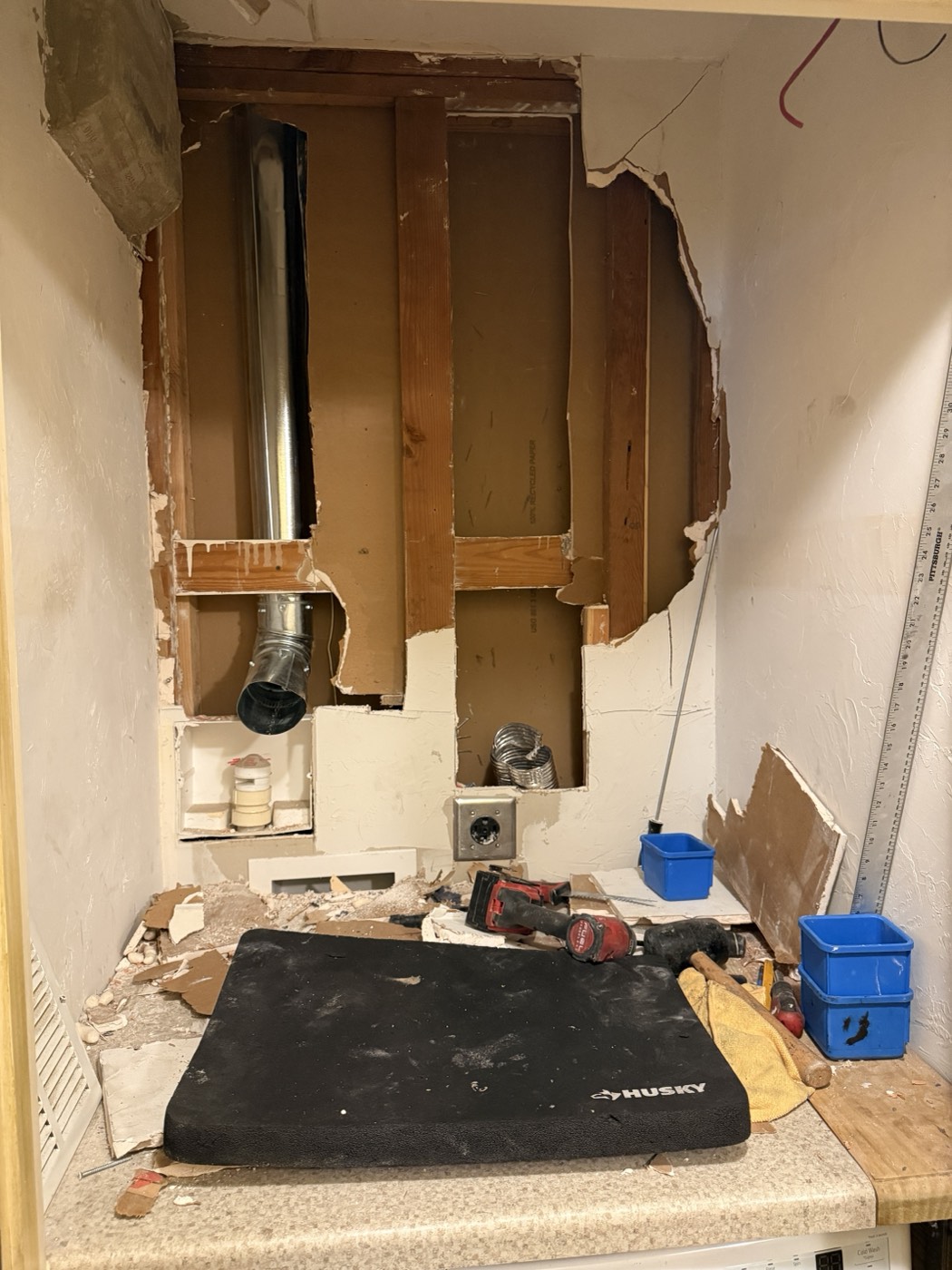 Wall opened up to reach and replace the in-wall dryer vent pipe